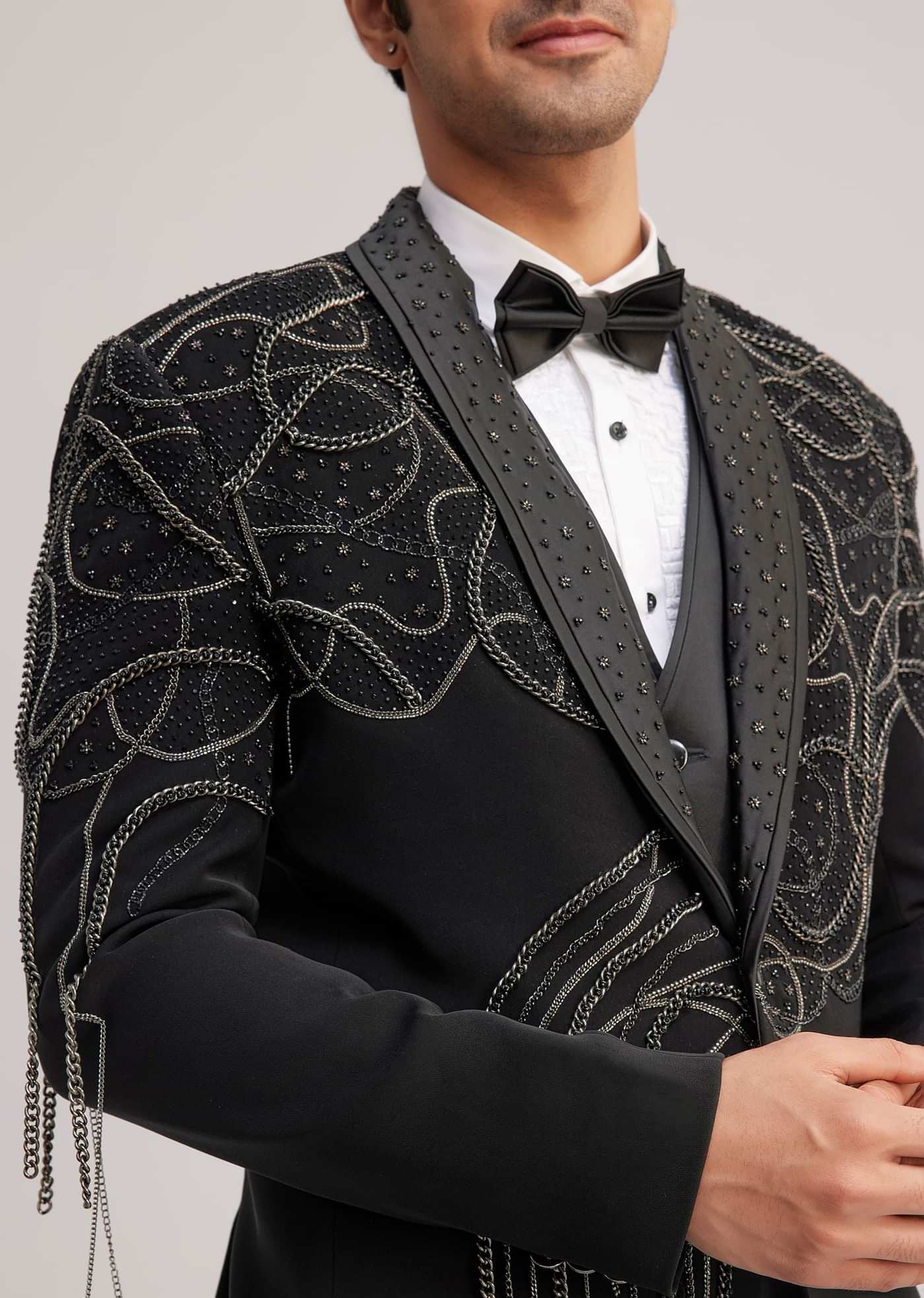 Black Suiting Tuxedo With Metallic Chain And Stone Work