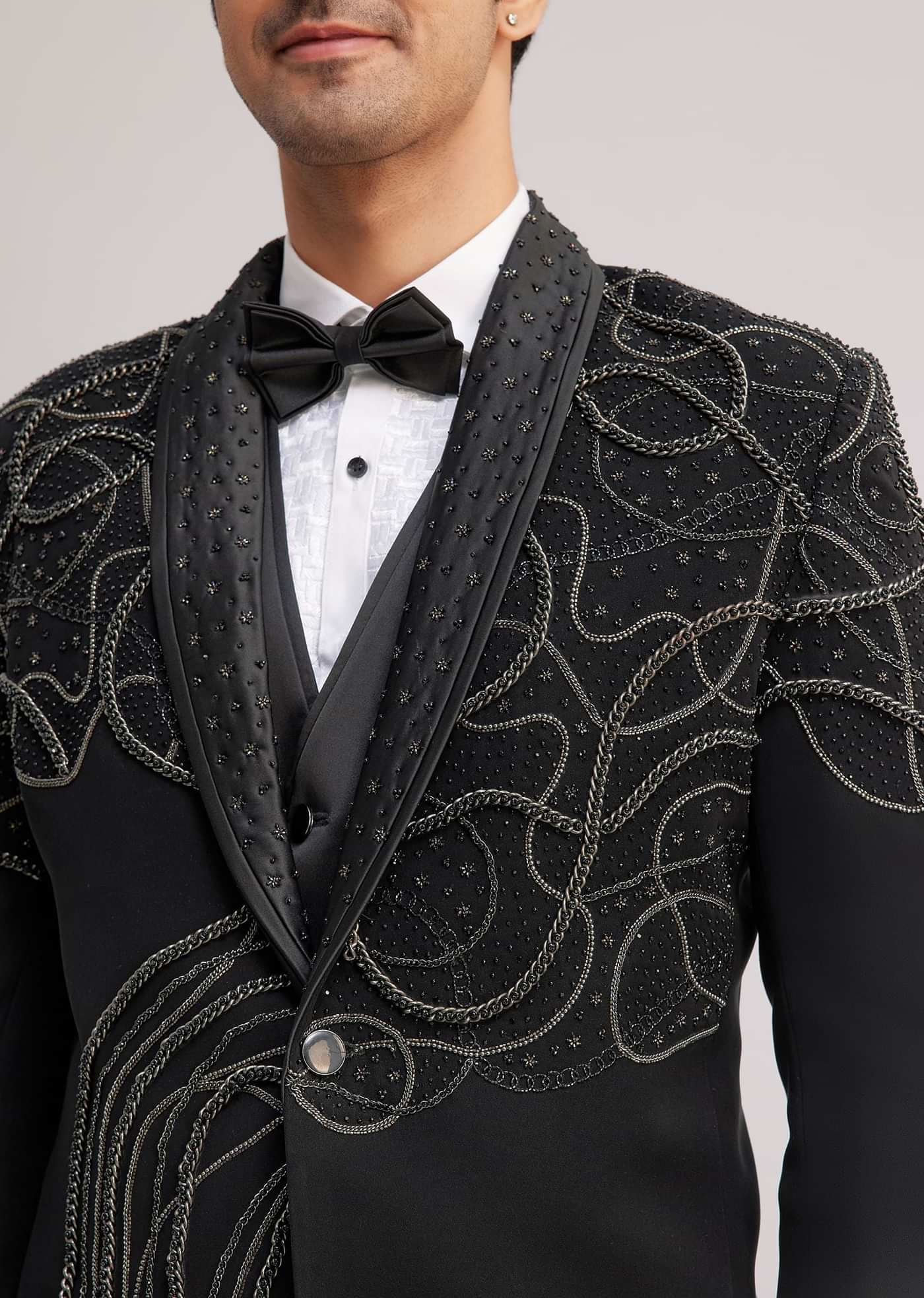 Black Suiting Tuxedo With Metallic Chain And Stone Work
