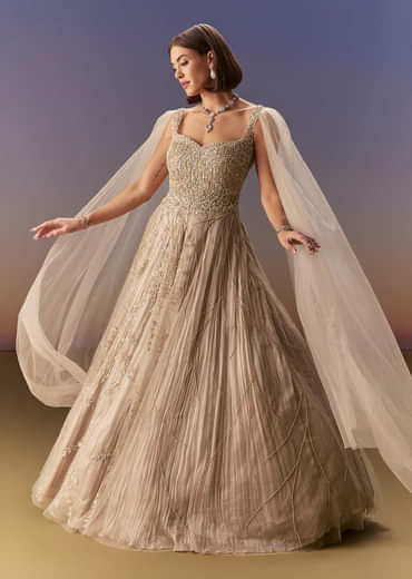 Gold Gown With Pleated Panels And Dramatic Cape