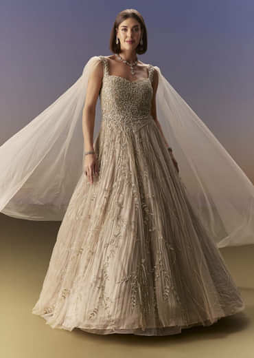 Gold Gown With Pleated Panels And Dramatic Cape