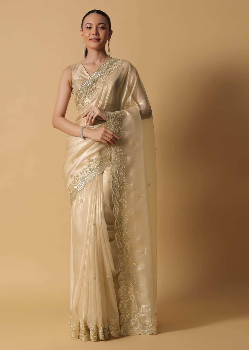 Gold Toned Foil Saree Fabricated In Tissue With Cut Dana Embellished Borders
