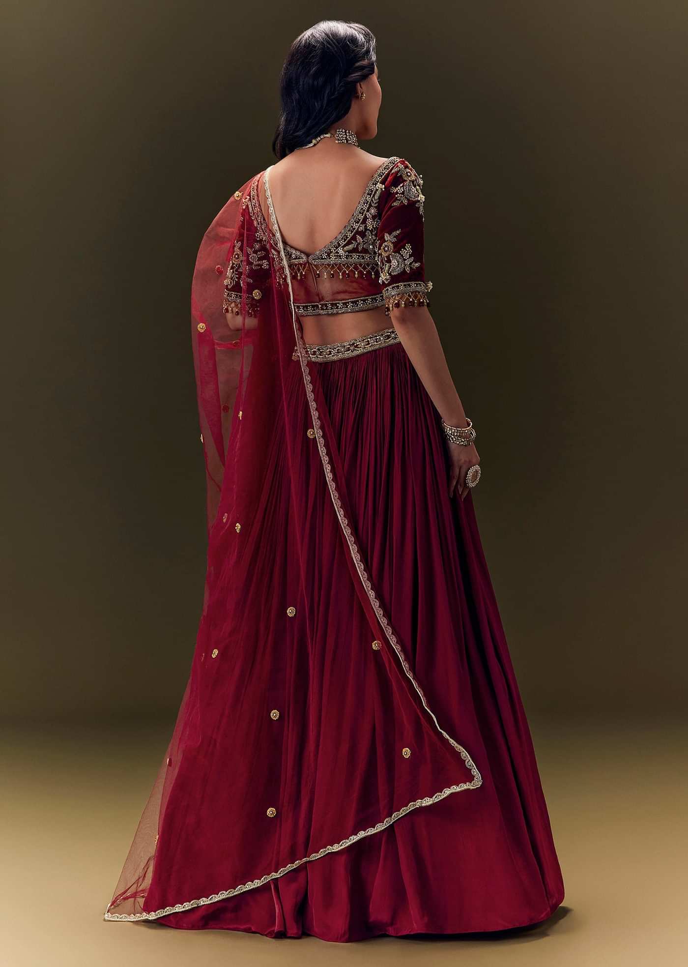 Maroon Pleated Skirt With Hand Embroidered Velvet Belt And Blouse With Net Dupatta