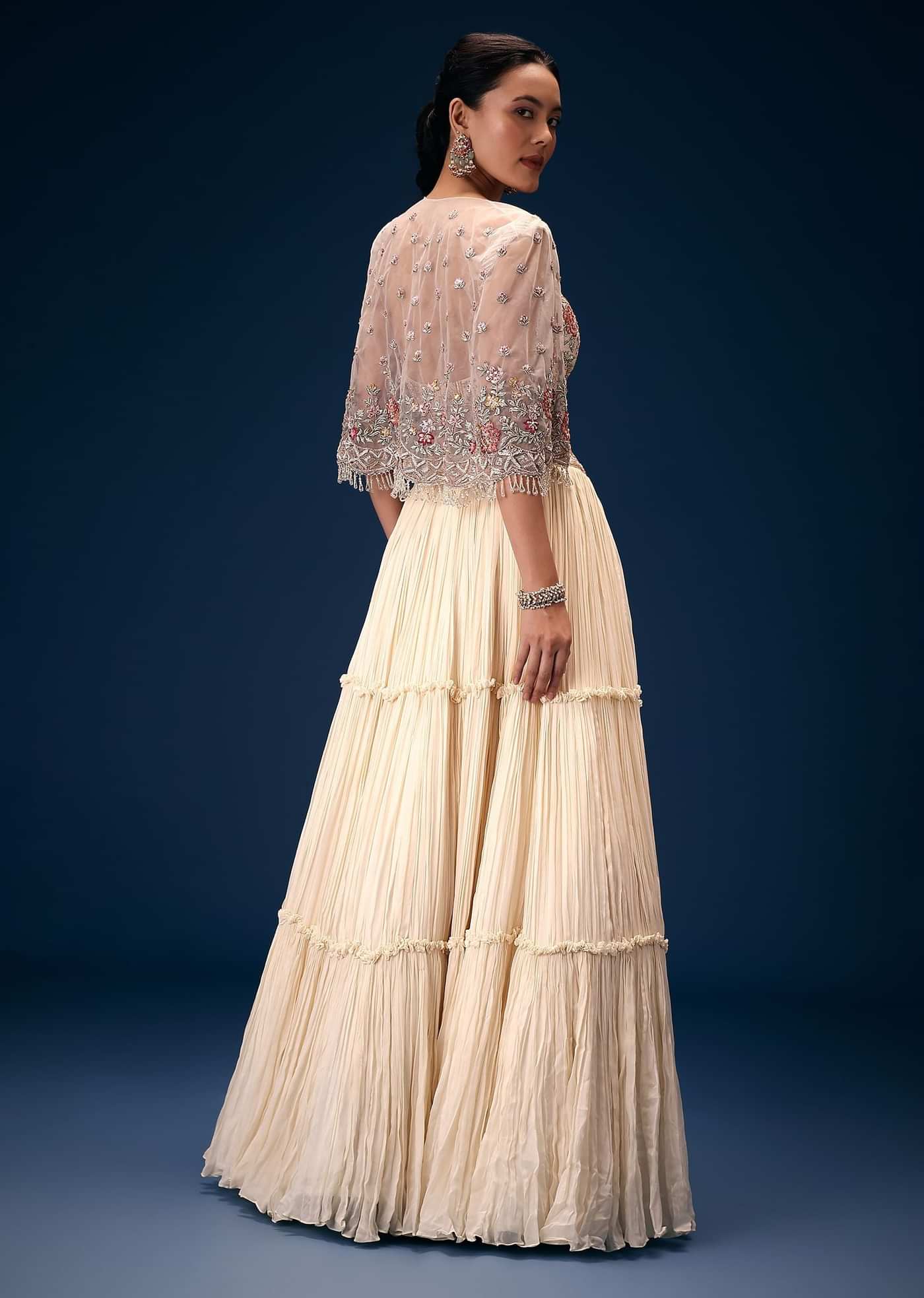 Off White Tiered Lehenga With Embroidered Corset Blouse And Embroidered Cape