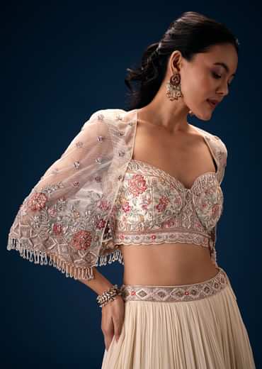 Off White Tiered Lehenga With Embroidered Corset Blouse And Embroidered Cape