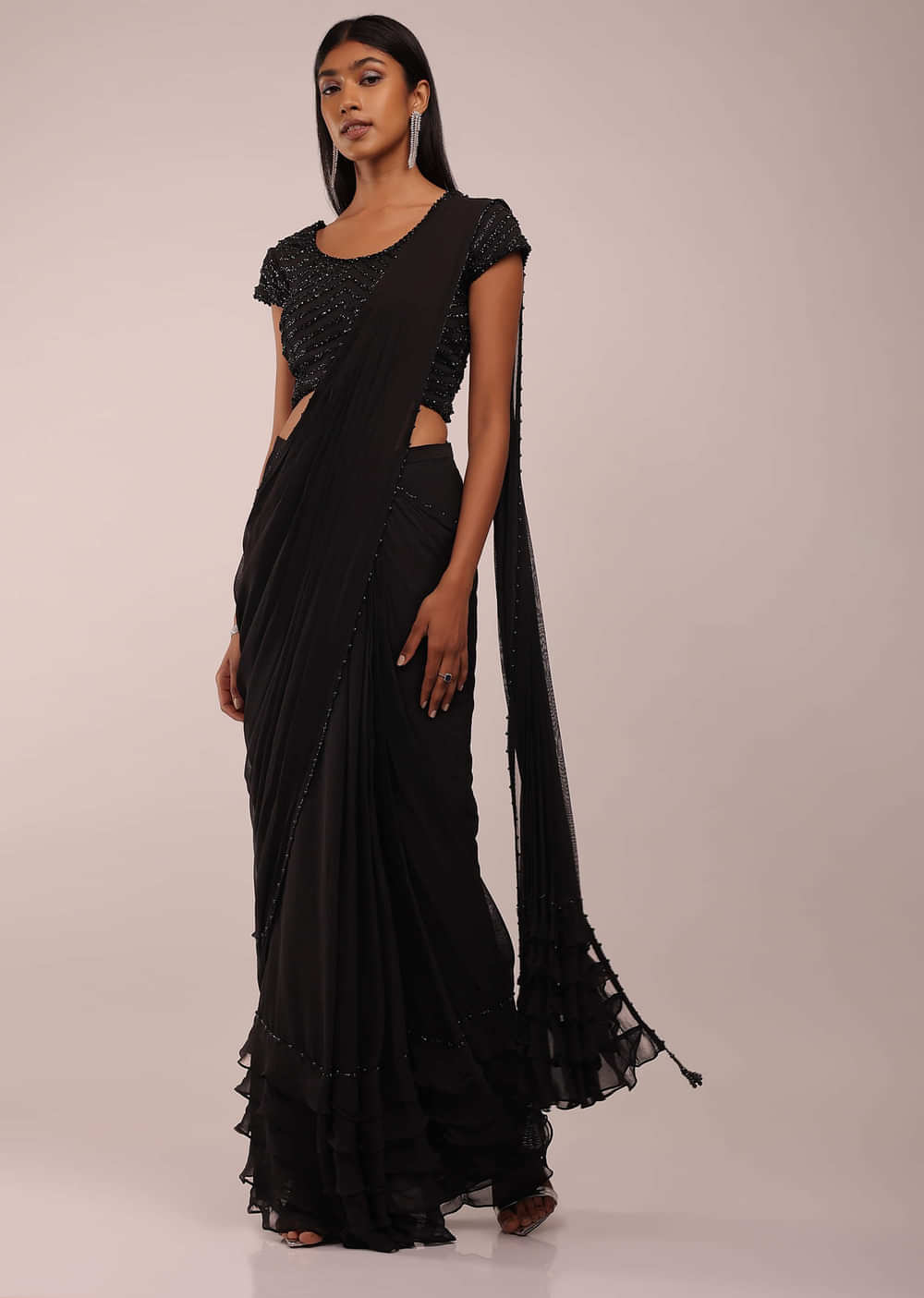 Pitch Black Saree With Three Tones Of Layered Frills On The Bottom Embellished In Stones And Sequins With A Tassel On The Pallu Corner