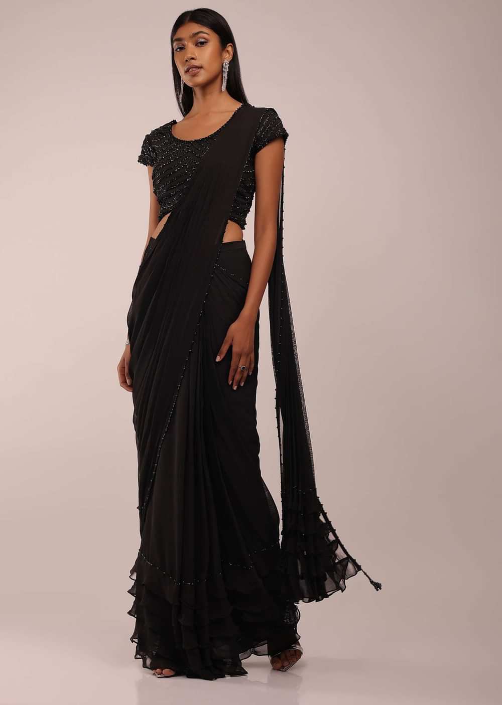 Pitch Black Saree With Three Tones Of Layered Frills On The Bottom Embellished In Stones And Sequins With A Tassel On The Pallu Corner
