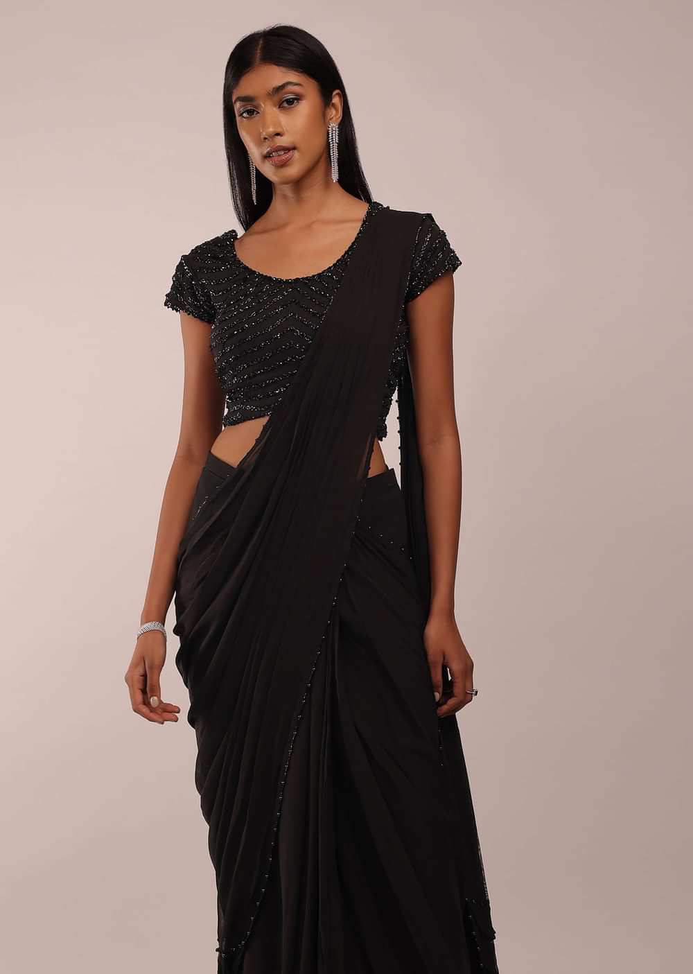Pitch Black Saree With Three Tones Of Layered Frills On The Bottom Embellished In Stones And Sequins With A Tassel On The Pallu Corner