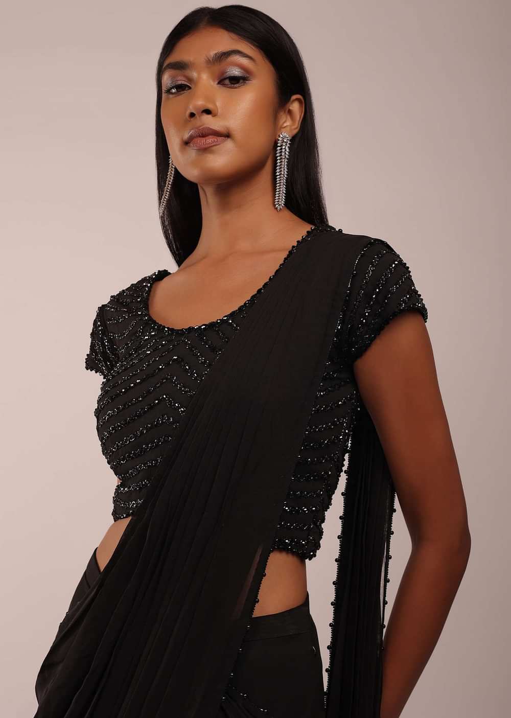 Pitch Black Saree With Three Tones Of Layered Frills On The Bottom Embellished In Stones And Sequins With A Tassel On The Pallu Corner