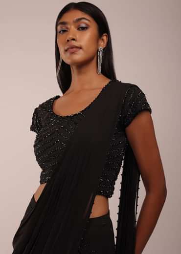 Pitch Black Saree With Three Tones Of Layered Frills On The Bottom Embellished In Stones And Sequins With A Tassel On The Pallu Corner