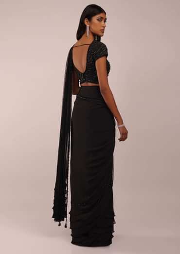 Pitch Black Saree With Three Tones Of Layered Frills On The Bottom Embellished In Stones And Sequins With A Tassel On The Pallu Corner