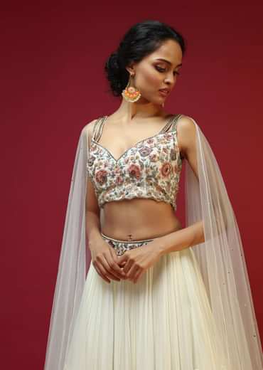 Powder White Lehenga Choli With Attached Cape And Hand Embroidery Using Colorful Resham And Sequins In Floral Motifs