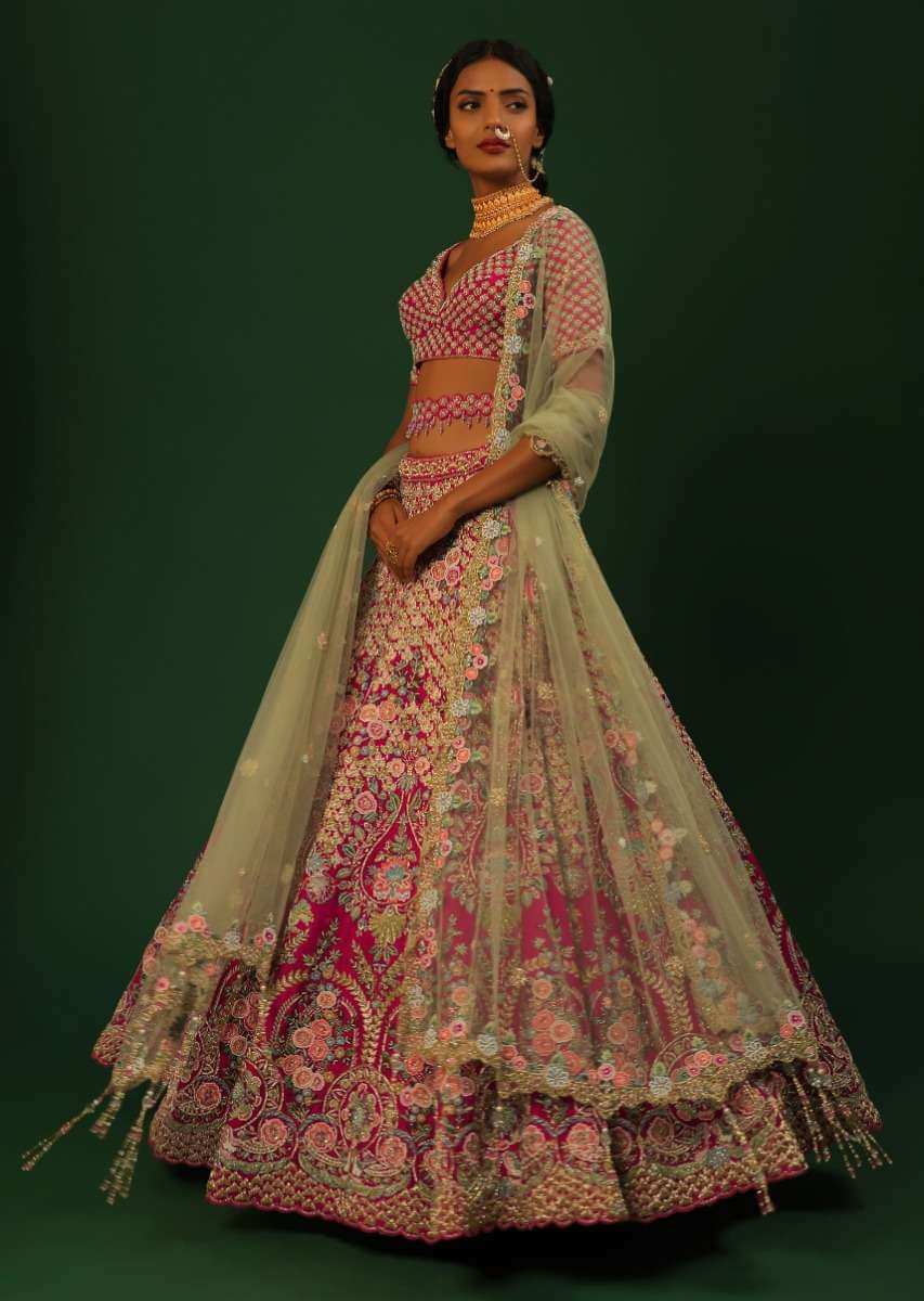 Rani Pink Lehenga Choli In Raw Silk With Heavy Embroidered Kalis Using Colorful Resham And Cut Dana In Floral Motifs Online - Kalki Fashion