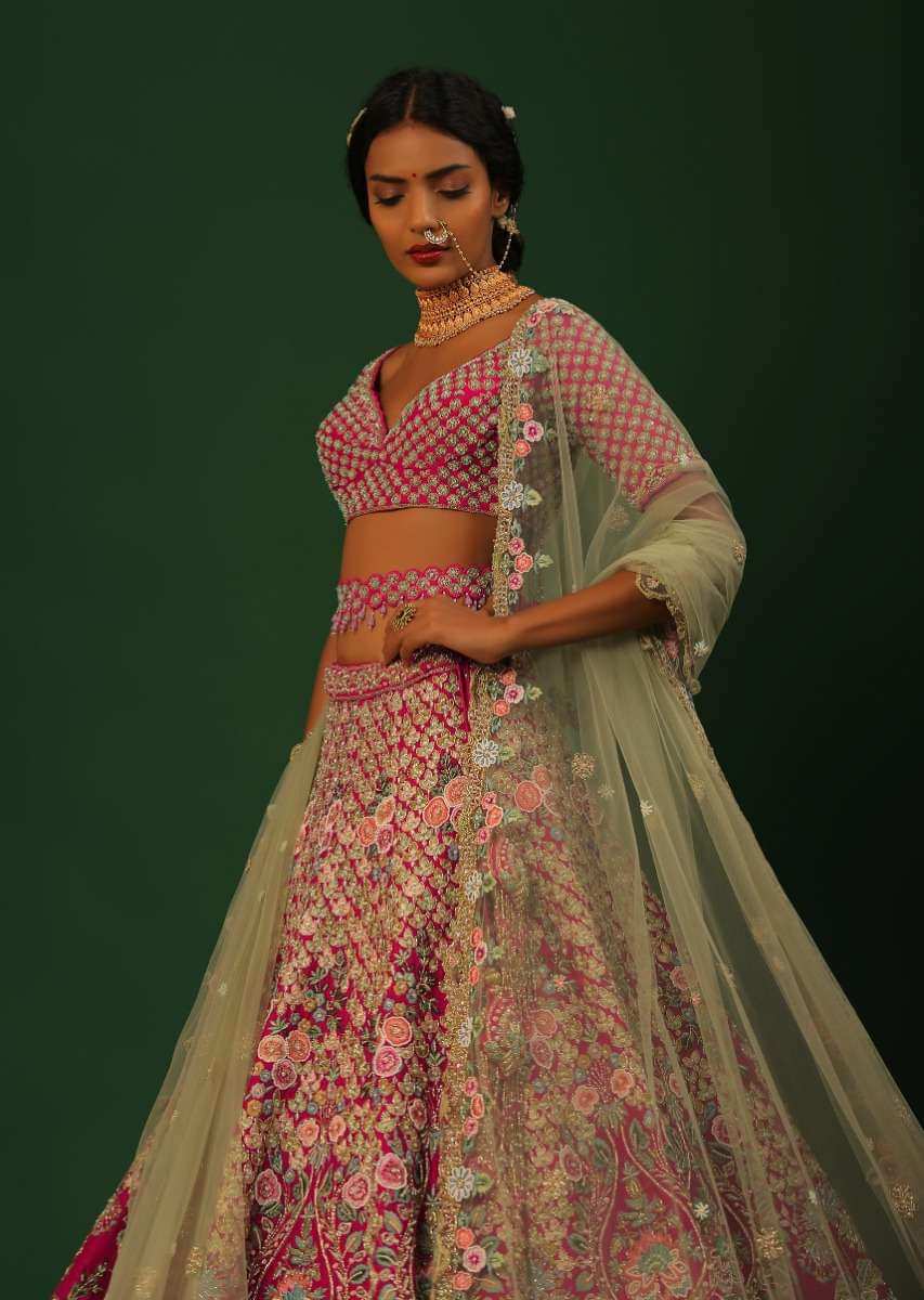 Rani Pink Lehenga Choli In Raw Silk With Heavy Embroidered Kalis Using Colorful Resham And Cut Dana In Floral Motifs Online - Kalki Fashion
