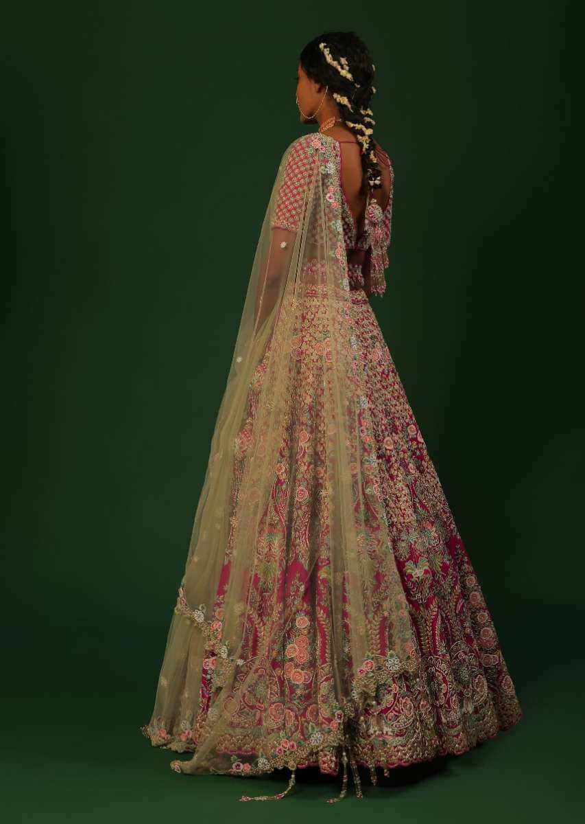 Rani Pink Lehenga Choli In Raw Silk With Heavy Embroidered Kalis Using Colorful Resham And Cut Dana In Floral Motifs Online - Kalki Fashion
