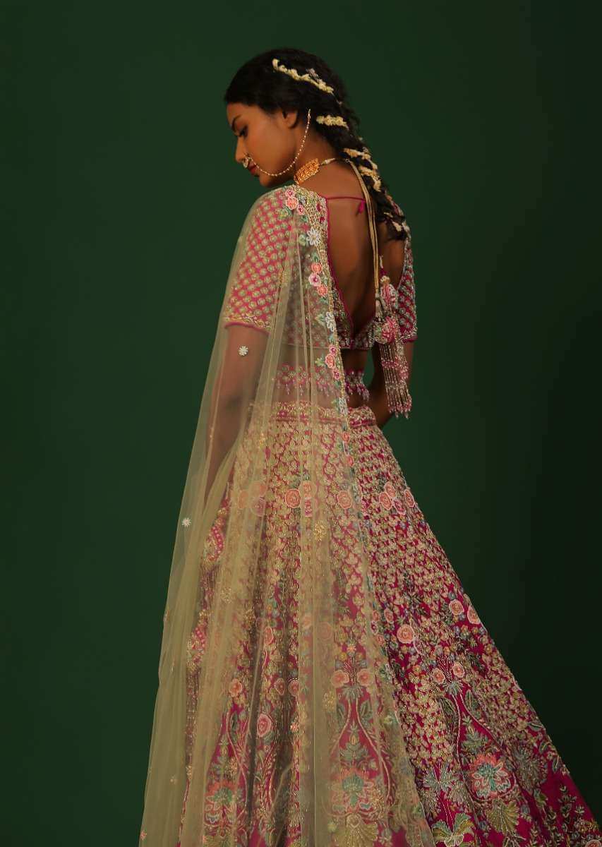 Rani Pink Lehenga Choli In Raw Silk With Heavy Embroidered Kalis Using Colorful Resham And Cut Dana In Floral Motifs Online - Kalki Fashion