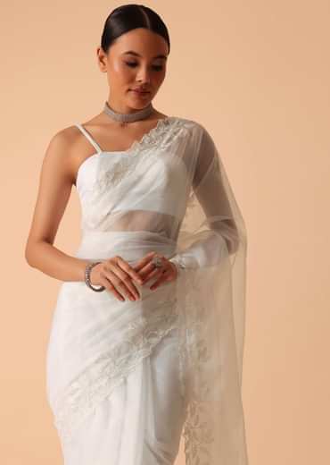 White Saree In Organza With Floral Motif Border And Unstitched Blouse Piece