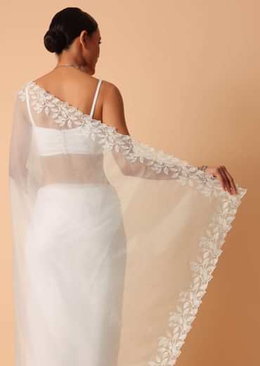 White Saree In Organza With Floral Motif Border And Unstitched Blouse Piece